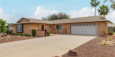 Clean exterior with attached two-car garage and extended driveway. This updated Sun City home provides convenience, storage, and modern upgrades.