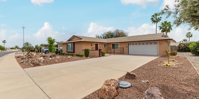 Side angle highlighting the home s structure, landscaping, and spacious lot. Located in Sun City, this property offers low-maintenance outdoor living.