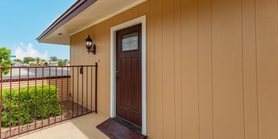 Close-up of upgraded front entry door with modern hardware. This Sun City home showcases thoughtful updates and welcoming design.