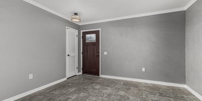 Entryway with sleek tile flooring, fresh paint, and updated lighting. This Sun City home offers a clean, contemporary interior feel.