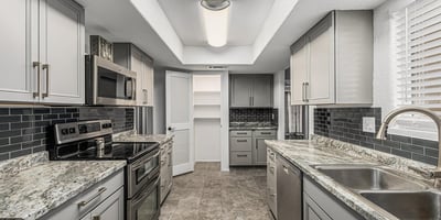 Efficient galley kitchen with ample cabinetry, modern lighting, and upgraded finishes. This Sun City home offers a practical layout for daily living.