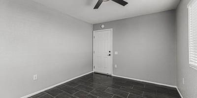 Flexible interior space with tile flooring and ceiling fan. This Sun City home provides options for office, guest room, or hobby area.