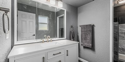 Updated bathroom vanity with sleek countertop, modern fixtures, and bright lighting. This Sun City home offers refreshed spaces with stylish upgrades.