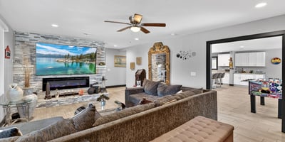 Open layout connecting living and kitchen spaces, featuring recessed lighting and contemporary updates in this Phoenix property.