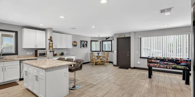 Expansive open-concept space with updated kitchen, modern flooring, and ample room for gathering, perfect for today s Phoenix lifestyle.