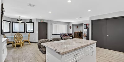 Kitchen island with bar seating connects seamlessly to living and dining areas, ideal for entertaining in this Phoenix home.