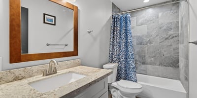 Functional full bathroom with tub-shower combo, updated tile, and clean finishes.