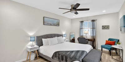 Bright and airy primary bedroom with modern flooring, workspace, and natural light designed for relaxation in this Scottsdale residence.