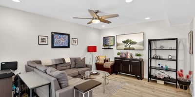 Spacious Scottsdale living room with modern finishes, recessed lighting, and open flow into the dining area perfect for relaxing or entertaining.