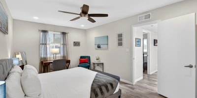 Comfortable Scottsdale bedroom with ceiling fan, updated flooring, and generous space for relaxing and unwinding.