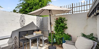 Scottsdale outdoor space featuring dining table, decorative elements, and lush plants for an inviting entertaining area.