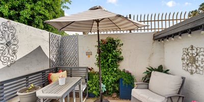 Peaceful Scottsdale patio with umbrella, seating, and landscaped touches, ideal for enjoying quiet outdoor moments.