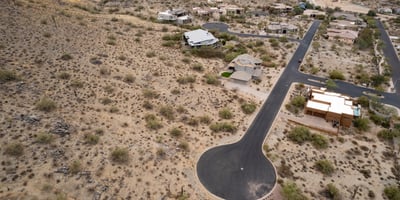 Expansive aerial view of this premium hillside lot surrounded by custom homes and breathtaking desert scenery. An ideal Phoenix location for building a luxury residence with mountain views.