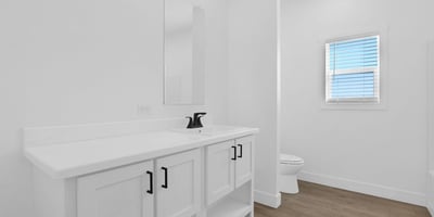 Well-appointed hall bathroom with contemporary finishes, stylish cabinetry, updated fixtures, and durable flooring. The bright design and functional layout make it ideal for family members and guests alike.