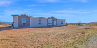 Exterior perspective highlighting the home's expansive acreage and scenic desert surroundings. The large lot provides privacy, flexibility, and room to create the lifestyle you've always wanted.