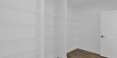 Large walk-in pantry offering extensive shelving and exceptional storage capacity. Designed to keep kitchen essentials organized while maximizing convenience and functionality.