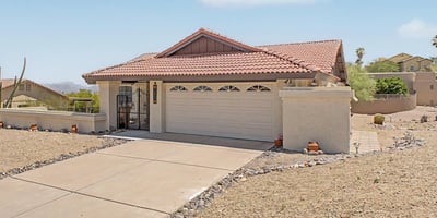 This charming home features a covered entry, spacious driveway, and thoughtfully designed exterior. The elevated setting enhances privacy while embracing the natural beauty of the surrounding desert landscape.