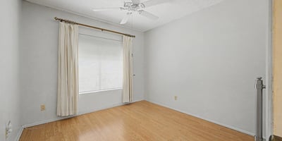 This comfortable bedroom features durable flooring, neutral colors, and excellent natural light. The flexible space can function as a guest room, office, fitness room, or additional sleeping area.