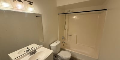 Full bathroom equipped with a modern vanity, updated lighting fixture, and tub-shower combination. Neutral finishes and practical design elements make this space ideal for everyday use.