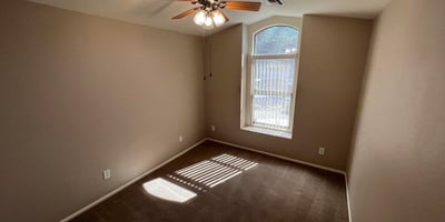Flexible secondary bedroom with natural light, ceiling fan, and neutral finishes. Suitable for guests, family members, a home office, or additional living space in this inviting Goodyear home.