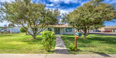 Attractive landscaping, fresh exterior paint, and a charming covered entrance combine to create a warm and inviting first impression for this Buckeye property.