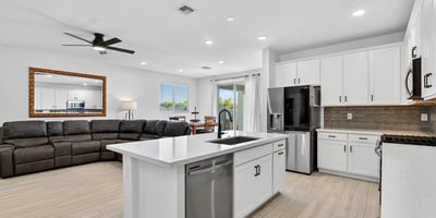 Designed for modern living, this beautiful kitchen features quartz countertops, stainless steel appliances, a large center island, abundant cabinetry, and an open layout connecting seamlessly to the great room.