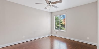 Large windows, wood flooring, and a ceiling fan make this upstairs bedroom bright, comfortable, and move-in ready. An excellent space for guests, family, or a home office.