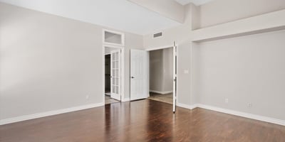 The spacious primary bedroom offers elegant wood flooring, vaulted ceilings, and excellent natural light. Its thoughtful layout provides plenty of room for additional seating and direct access to the ensuite bathroom.