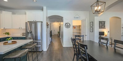 Expansive kitchen and dining area showcasing quartz countertops, oversized island seating, and a seamless flow that's ideal for hosting family and friends.