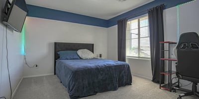 Inviting bedroom featuring plush carpeting, abundant natural light, and ample floor space for comfortable living. A flexible room suited for family, guests, or remote work.