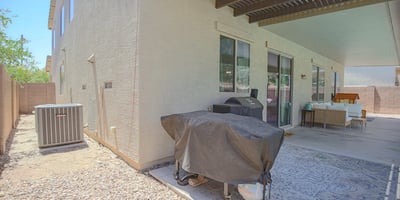 Covered patio with built-in grilling area, spacious seating, and convenient access to the backyard pool. A functional outdoor living area designed for entertaining in Waddell.