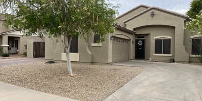 Generous backyard offers a spacious paver patio, grassy area, raised planter beds, and privacy walls, providing endless possibilities for entertaining or outdoor enjoyment.