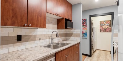 Discover this modern kitchen with upgraded appliances and unique artwork, perfect for culinary enthusiasts.