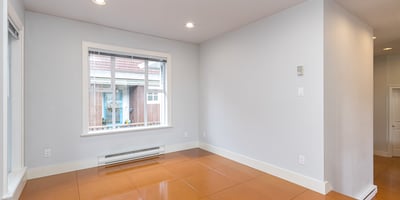 Bright and open space featuring large windows, perfect for personalizing as a cozy living area or studio.