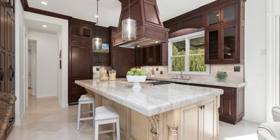 Discover a stunning kitchen featuring rich cabinetry, a spacious island, and modern appliances, perfect for entertaining.