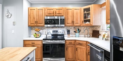 Charming kitchen with warm wood accents, Corian counters.