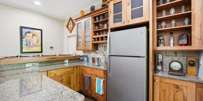 This well-appointed kitchen features ample storage, modern appliances, and a lovely granite countertop perfect for entertaining.
