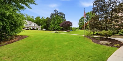 Expansive, well-maintained grounds offer ample space for outdoor activities and potential landscaping projects.