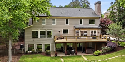 Spacious home with expansive outdoor living and large windows, perfect for enjoying the surrounding nature.