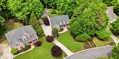 Discover a picturesque neighborhood featuring spacious homes surrounded by lush greenery and beautifully landscaped yards.