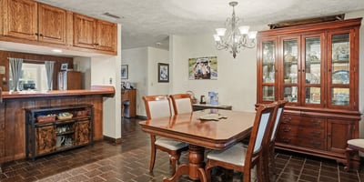 Dining area which can accommodate an eight-person table; the bar in the background opens to the Living Room.