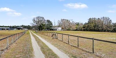 The private driveway boasts a solar-powered gate! Solar powered lighting lights the entry after dark.