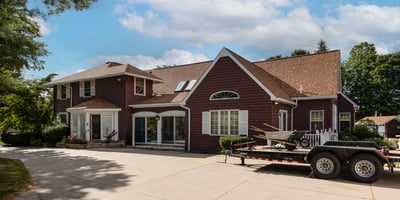 Spacious home featuring a large driveway, bright interiors, and a welcoming outdoor space for gatherings.