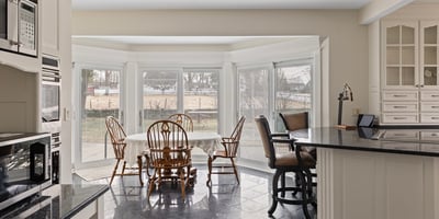 Spacious kitchen features large bay windows, ideal for natural light and relaxed dining experiences.