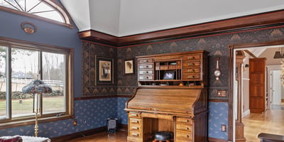 Spacious living area featuring unique architectural details and rich wood finishes, perfect for relaxation and gatherings.