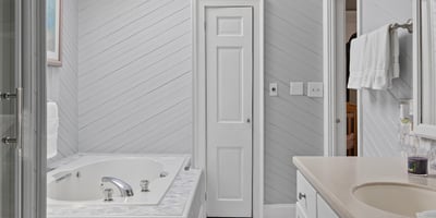 Bright and airy bathroom featuring a skylight, spacious jacuzzi, and modern fixtures for a refreshing retreat.