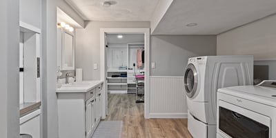 Bright and functional laundry room featuring modern appliances and ample storage space for organization.