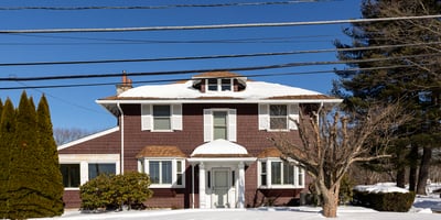 Spacious two-story home with ample outdoor space, located in a peaceful, snow-covered neighborhood.