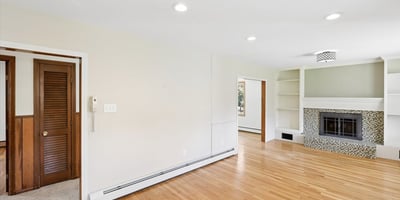 Spacious living area featuring a cozy fireplace and built-in shelves, perfect for personalized decor.