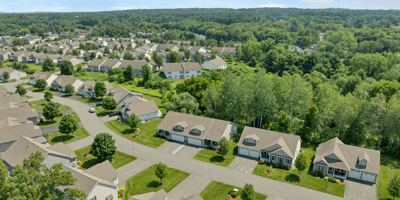 Spacious community with well-maintained homes, surrounded by lush greenery and convenient access to local amenities.